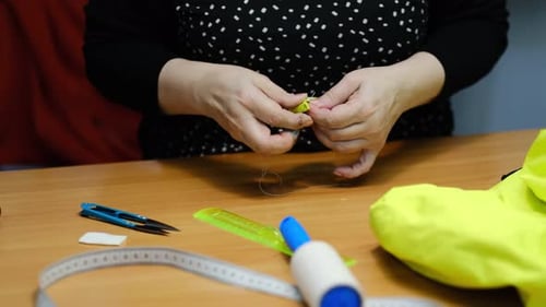 Female Seamstress Working with Textile for Sewing Clothes Close Up View of Sewing Process Light