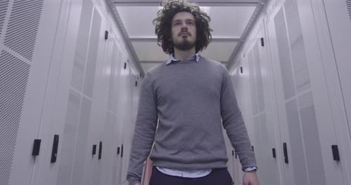 Man Walking Through Modern Server Room