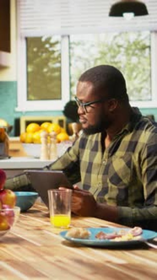 Vertical Video Black Working Dad on Tablet Ignoring Son and Family at Breakfast Table