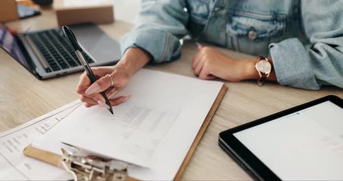 Hands Writing on Form at Office Desk