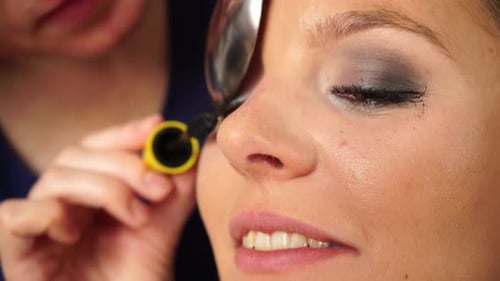 Woman Receiving Mascara Eyelash Makeup Application