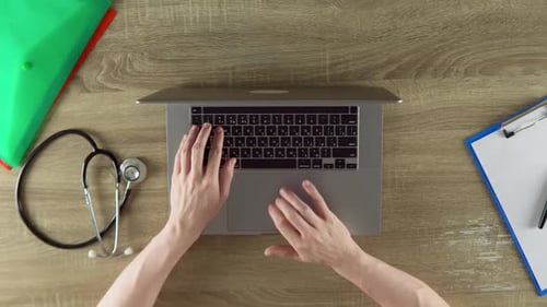 Typing on Laptop at Doctor's Office Overhead