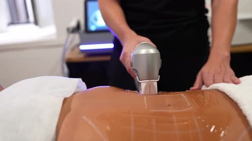 Woman Receiving Abdomen Treatment with Ultrasound Device
