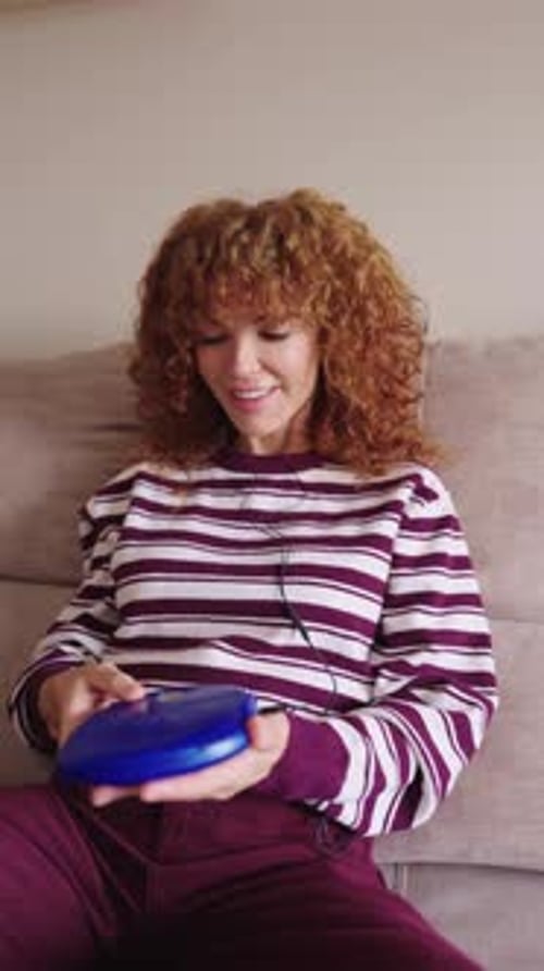 Nostalgic Redhead Woman Listening Music on Cd Player