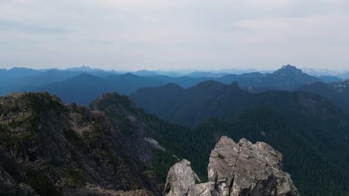 Aerial Cinematic View of Rocky Mountain Landscape Cloudy Sunny Day Taken in BC Canada