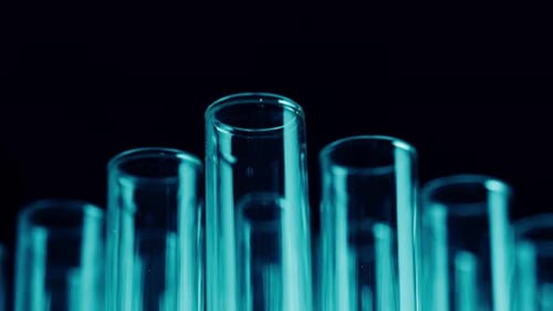 Close Up Video Neon Blue Light Test Tubes in a Laboratory Scientific Experiment Research Study