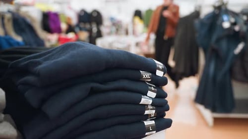 FirstPerson View of Male Boxer Sizes on Display in Mall with Blurred Background