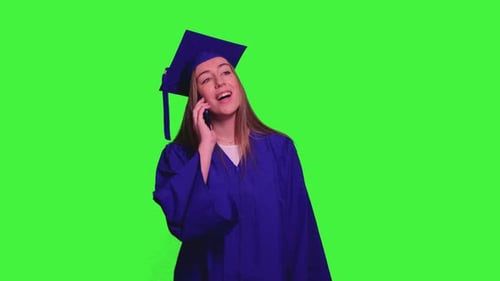 Graduated student using smartphone and talking on the phone on green screen