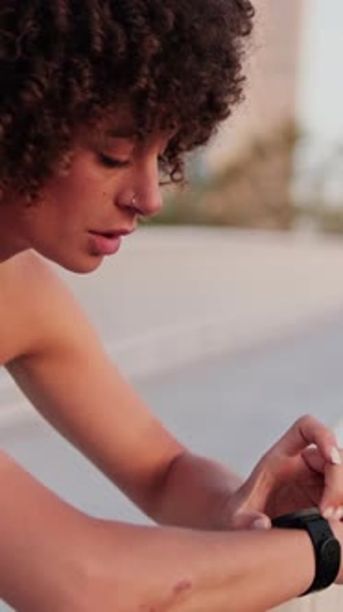 Young Woman Using Smartwatch During Workout