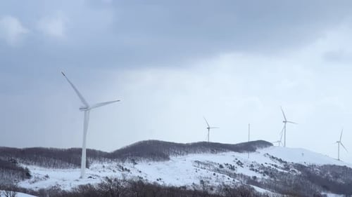 Wind power plants are seen in the snow-covered mountain, South Korea