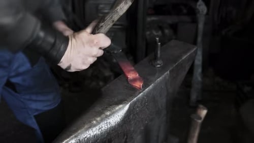 Blacksmith Hands Hammering Hot Glowing Steel on Anvil Closeup Traditional Metal Forging Workshop