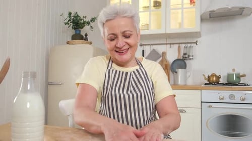 Senior Woman Baking Dough in Bright Kitchen