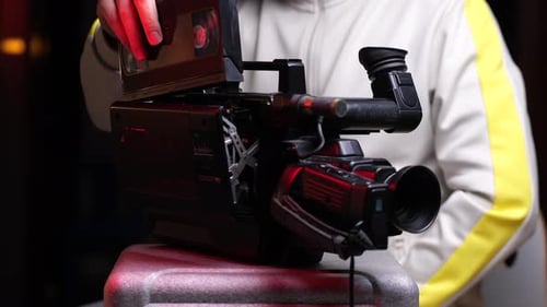 Hombre insertando un casete Vhs en una vieja videocámara Vhs vintage