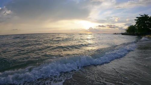 Slow Motion of Ocean Wave at Sunset on a Beach