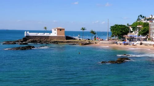 Aerial view of Santa Maria Fort, the beach, the neighborhood, some boats parked and the Farol da Bar