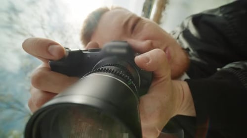 Photographer Taking Photos with DSLR Camera Outdoors