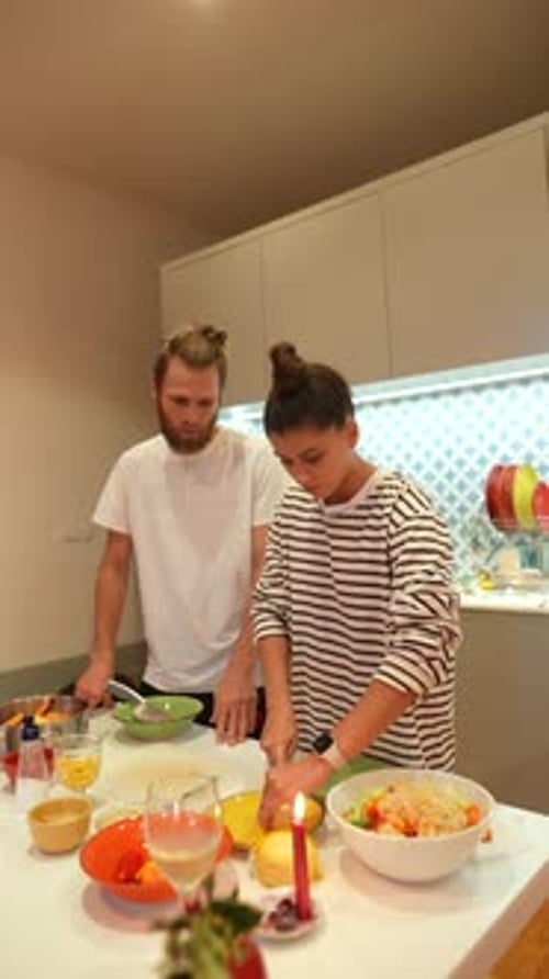 Young Adults Cooking Together in Kitchen