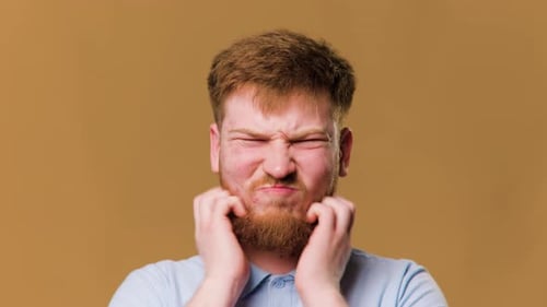 A Closeup Studio Shot of a Male Head with Hair Showing the Discomfort