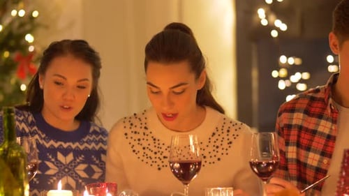 Friends eating Christmas dinner together during the holidays