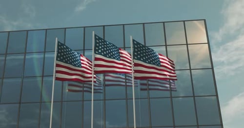 Three American Flags Waving on Modern Corporate Building