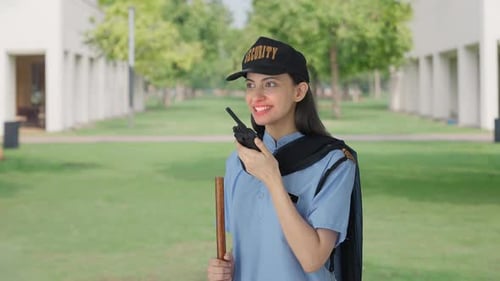 Smiling Security Guard Talking on Walkie Talkie