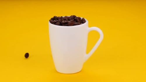 Coffee Beans in a White Mug on Yellow