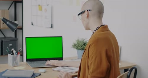Office Worker Using Green Screen Chroma Key Laptop Concentrated on Job in Workplace