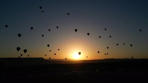 Sunrise with Hot Air Balloons in Scenic Landscape