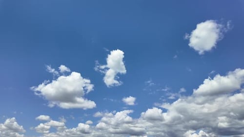 Cloudscape Low Angle View: Evolving Cottony Clouds Under an Intense Blue Sky