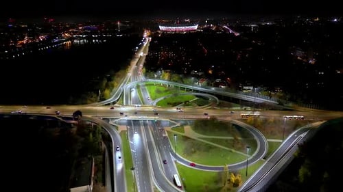 Drone view of the Metropolis Building at night and a street with heavy traffic. Crossroad Night capi