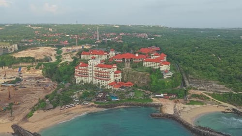 Aerial view of a tropical luxury hotel and resort complex on a sandy beach. Turquoise ocean waters
