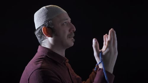 Adult Man In Prayer Holding Prayer Beads