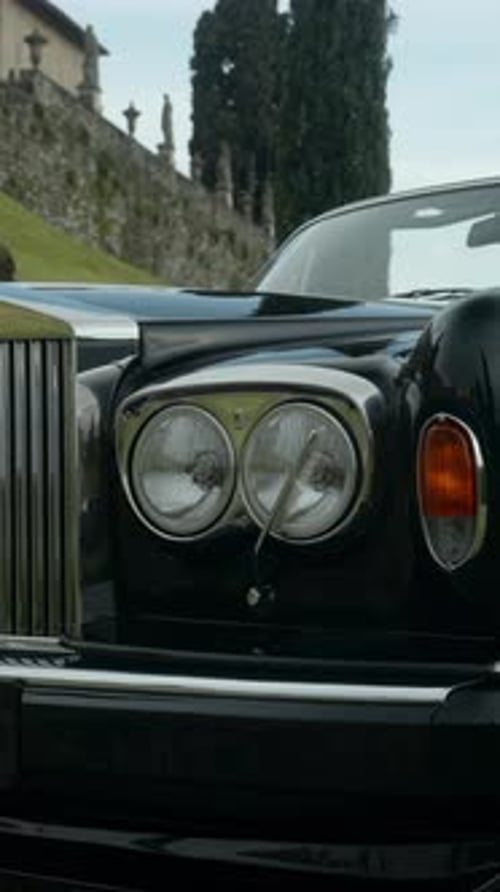 Luxurious Black Convertible Car Parked Near a Castle Action