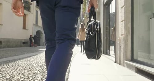 A handsome businessman in a suit, comes with a briefcase, at the city. Concept: a new business, tr