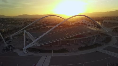 Aerial footage orbiting Olympic Stadium of Athens Greece at sunset
