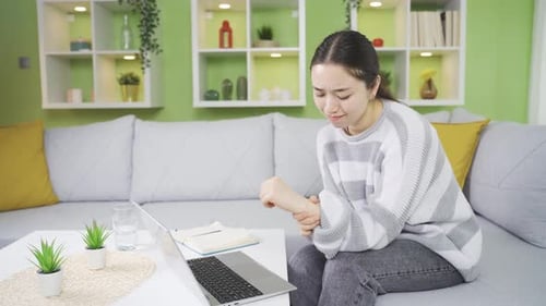 Young asian woman experiencing extreme tenderness, tingling, pain or discomfort in one or more bones
