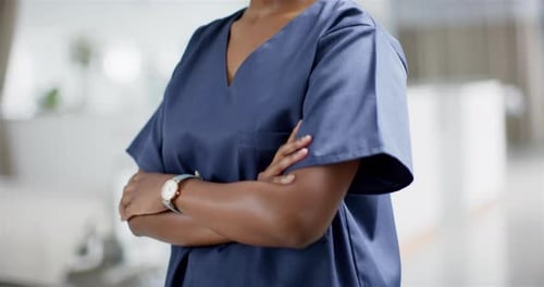 Portrait of happy african american female doctor wearing scrubs in hospital, slow motion