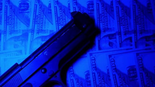 Handgun on Stack of US Hundred Dollar Bills