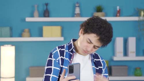 Unsuccessful young man turns the phone to the camera. Green screen.