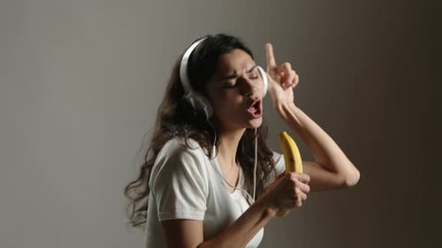Woman Sings into Banana Like Microphone