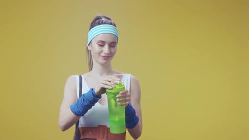 Recovery Session with Beverage Relaxation Active Woman Fueling Up with Electrolyte Drink During Rest