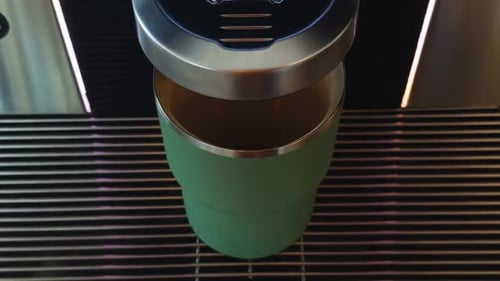 Coffee Pouring Into Green Travel Mug Close Up