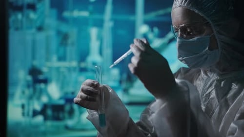 Scientist Working With Test Tube in a Blue Lab