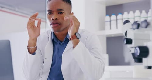Stressed Scientist Rubbing Temples in Laboratory Setting