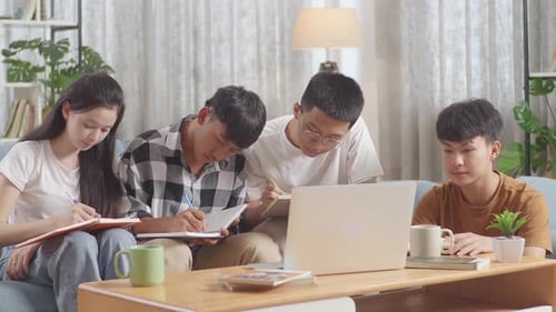 Students Collaborate Studying Using Laptop at Home
