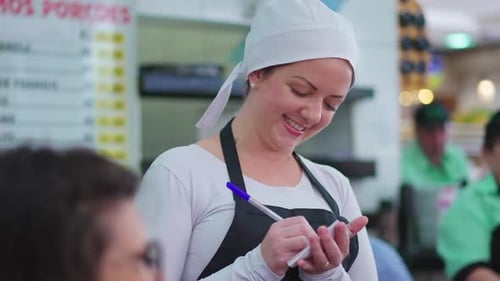 Cheerful Waitress Taking Food Orders, Engaging with Patrons in Restaurant Setting, Local business