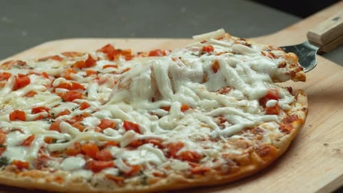 Slice Of Pizza Is Lifted From Board With Cheese Stretching, Slow Motion.