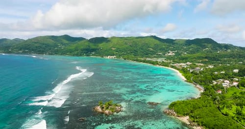 Expansive View of the Coastline with Waves Breaking Over a Coral Reef