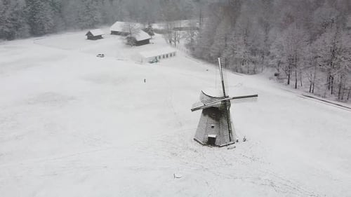 Historisches Mühlenhaus aus Holz mit Klingen in der Wintersaison, Ansicht der Luftbahn