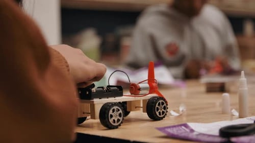 Girls in trades building engineering project of cars